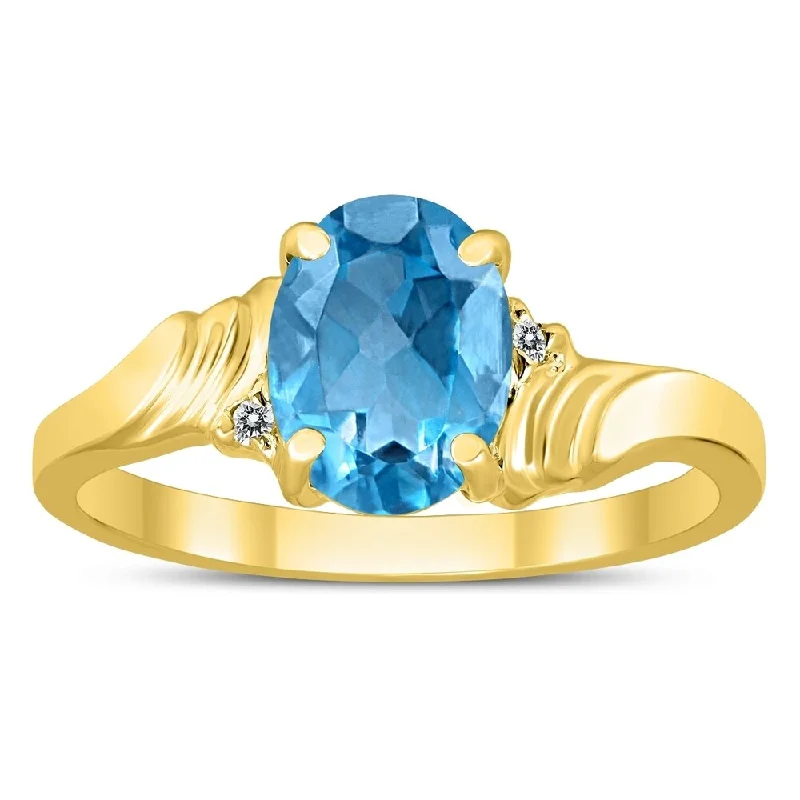 8X6MM Blue Topaz and Diamond Wave Ring in 10K Yellow Gold