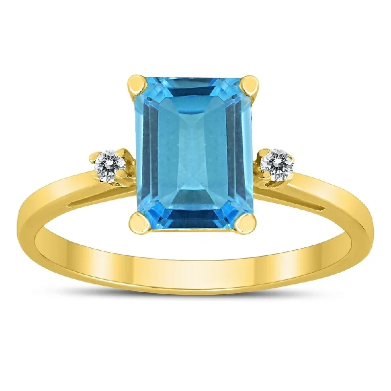 Emerald Cut 8X6MM Blue Topaz and Diamond Three Stone Ring in 10K Yellow Gold